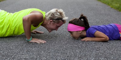 Mother and daughter doing push-ups